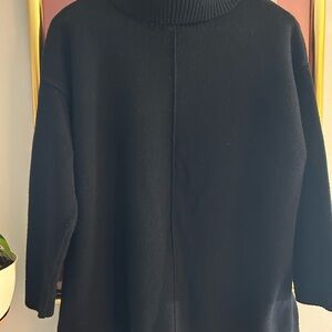 Black cowl neck, dropped shoulder sweater.